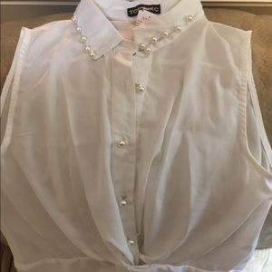 White, sleeveless, boutique shirt.